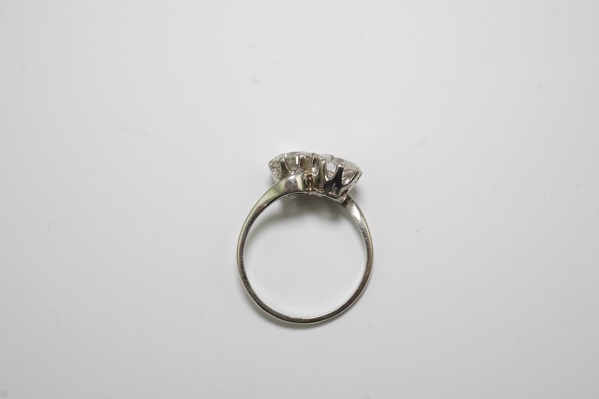 A platinum? and two stone diamond set crossover ring